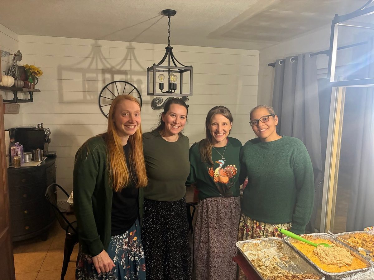 Church members with a table full of food